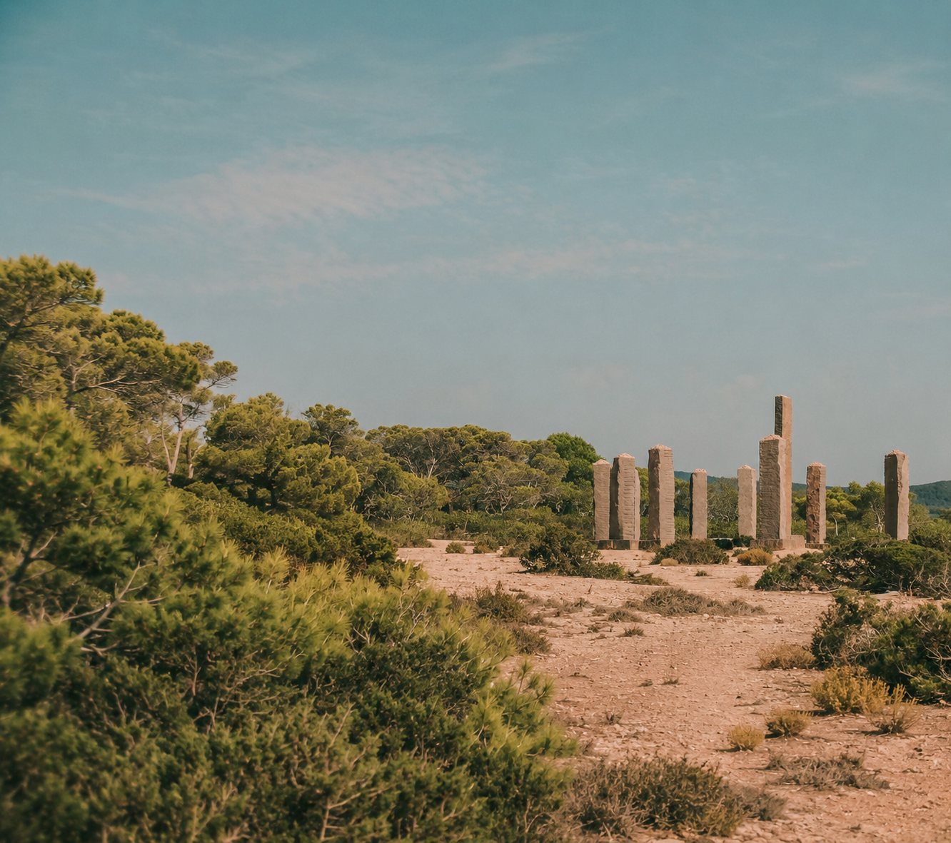 Stone columns standing among the pines of Cala Llentia, Ibiza